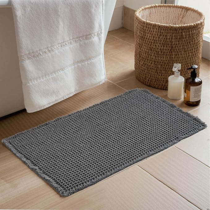 KGORGE Waffle Bath Mat, Super Absorbent 17" X 24" Farmhouse Ultra Soft Bathroom Rugs with Tassels for Bathroom Decor, Boho Non Slip Rubber Backed Shower Mats for Floor Bathtubs, Grey, 1pc